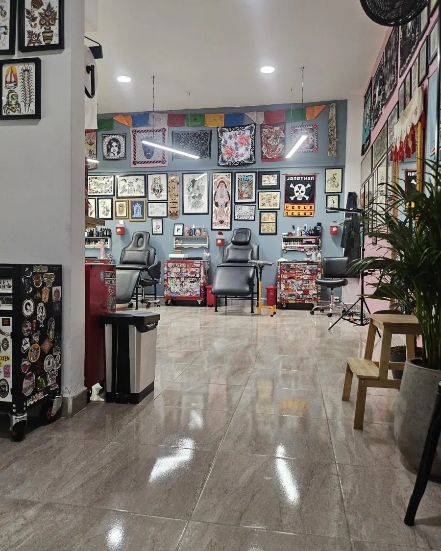 Interior del estudio Perla Negra, con camillas y paredes llenas de arte